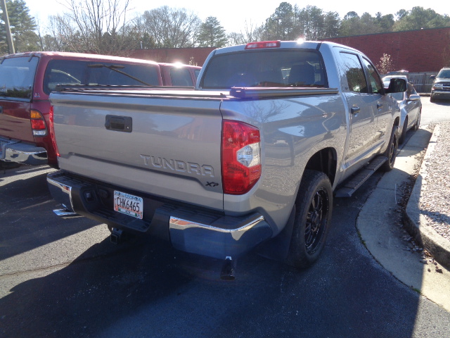 A 2018 Toyota Tundra showing the repair made to the passenger's side by the auto-body shop.