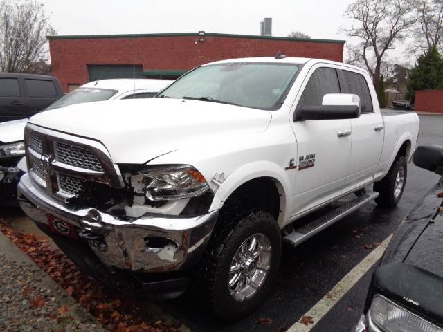 truck with damaged front headlight, bumper and hood